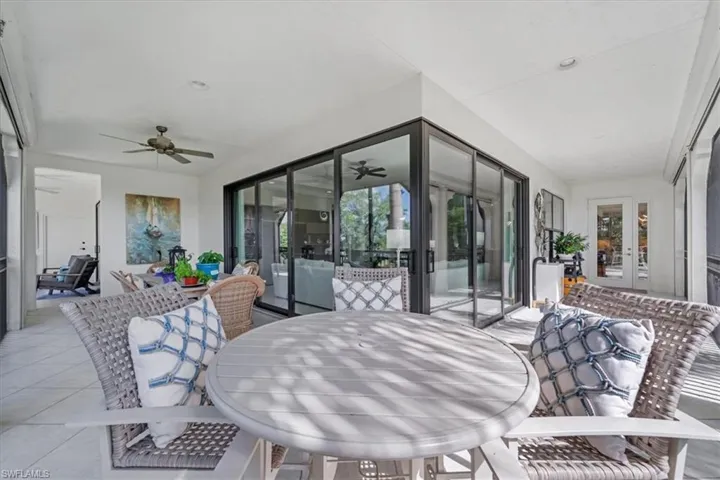 Sunroom with french doors, ceiling fan, and outdoor dining space