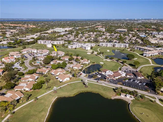 Birds eye view of property with a water view