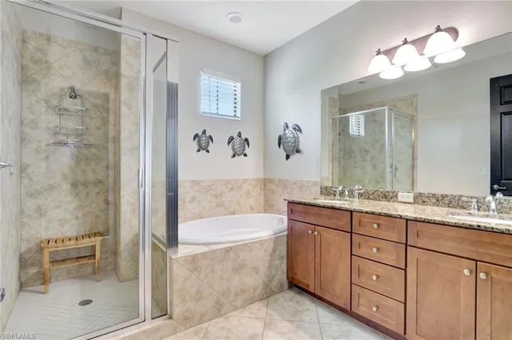 Bathroom with shower with separate bathtub, tile patterned flooring, and double sink vanity
