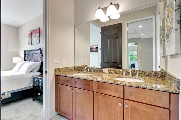Bathroom with double vanity and tile patterned flooring