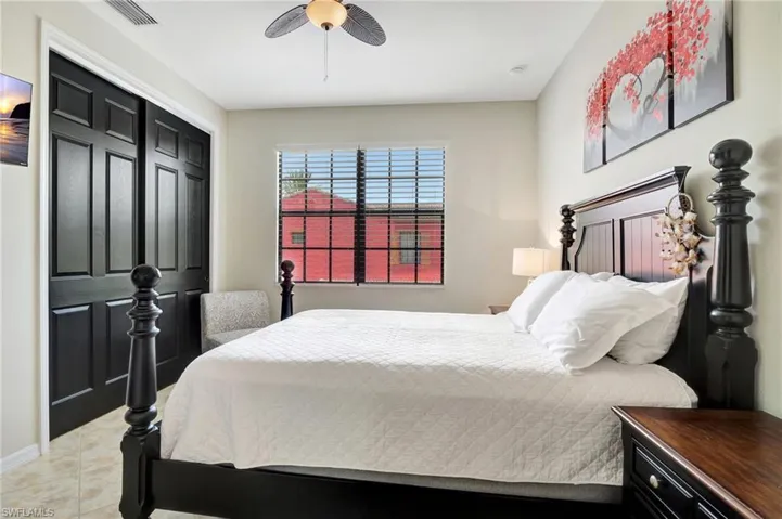 Tiled bedroom featuring a closet and ceiling fan