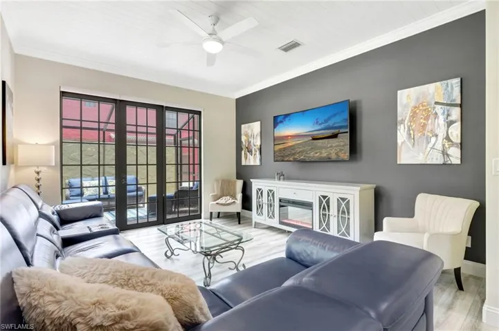 Living room with ceiling fan, french doors, light hardwood / wood-style flooring, and ornamental molding