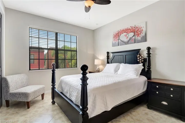 Bedroom with light tile patterned flooring and ceiling fan