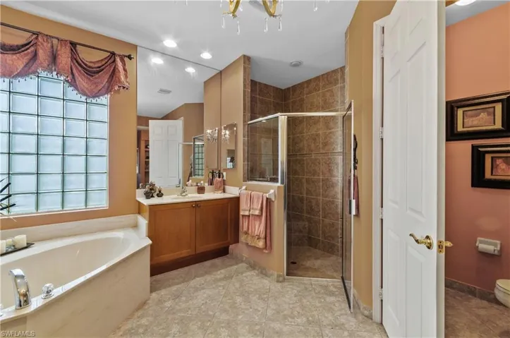 Full bathroom featuring vanity, toilet, independent shower and bath, and tile patterned flooring