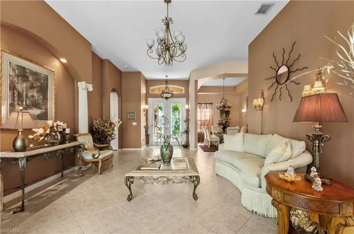 Living room featuring a chandelier and light tile patterned flooring