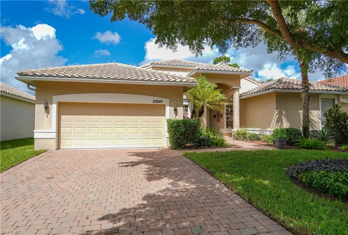 Mediterranean / spanish-style house featuring a garage and a front yard