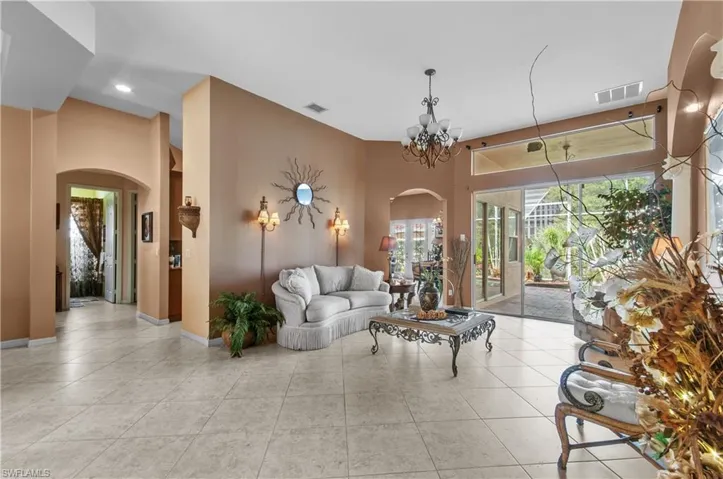 Tiled living room featuring a notable chandelier