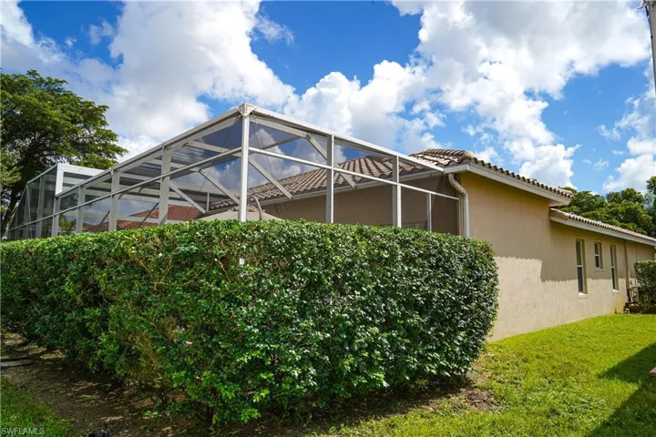 View of side of property with a lanai