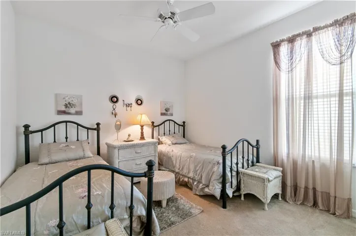 Bedroom with light colored carpet and ceiling fan