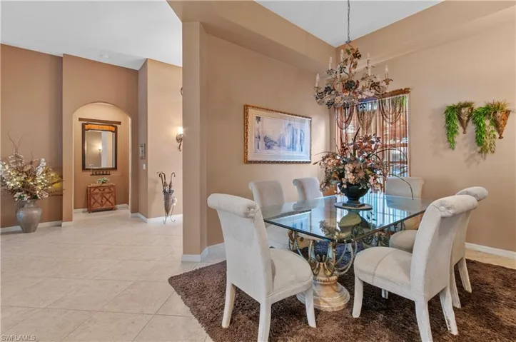 Tiled dining room with an inviting chandelier