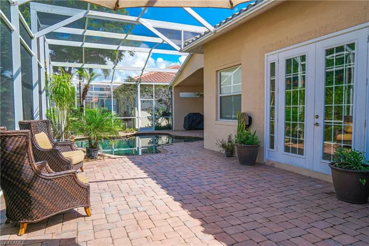View of patio featuring a lanai