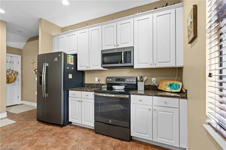 Kitchen featuring appliances with stainless steel finishes, white cabinets, recessed lighting, and baseboards