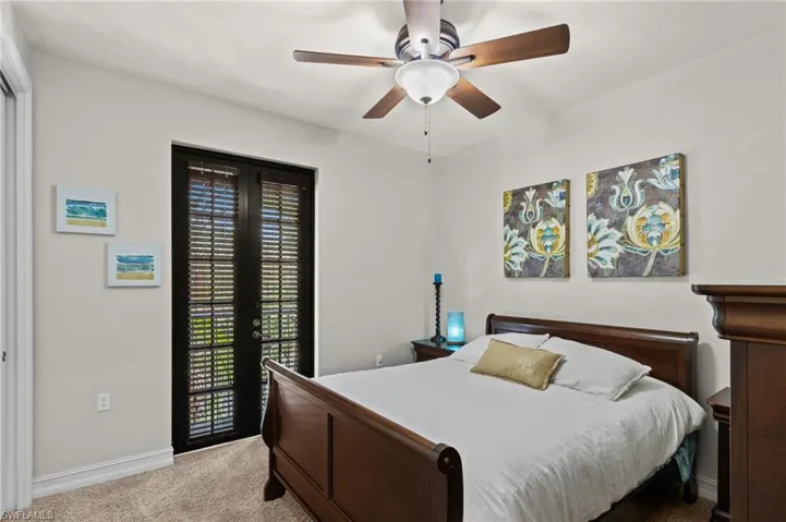 Carpeted bedroom with access to exterior, baseboards, and a ceiling fan