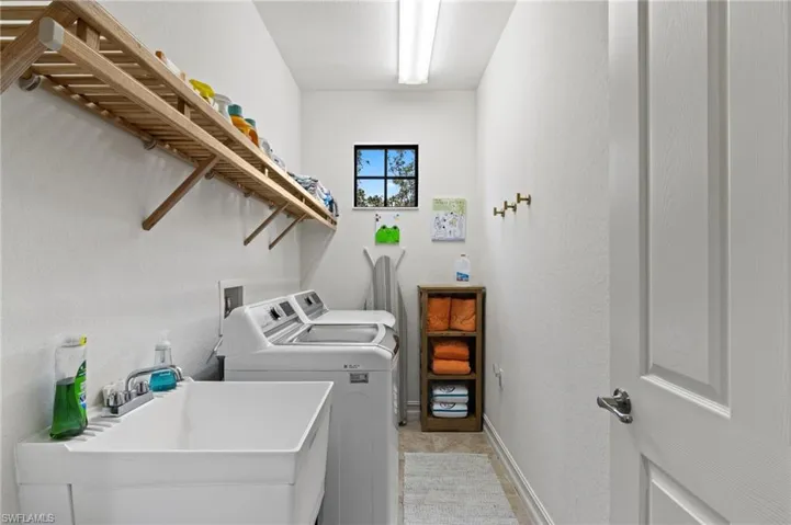 Laundry room featuring separate washer and dryer and baseboards