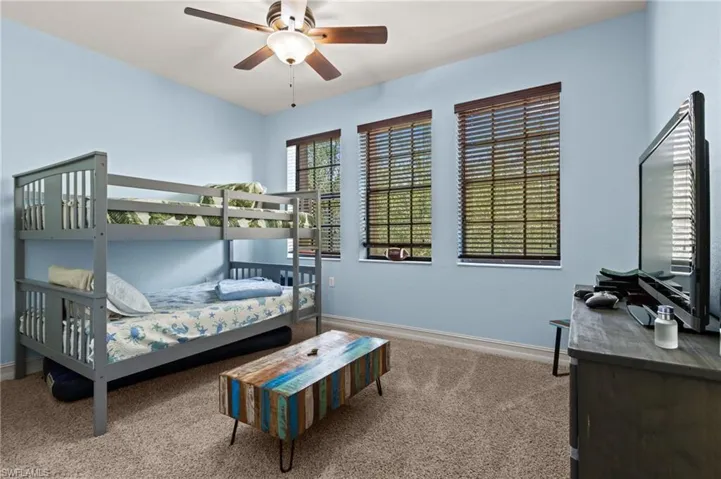 Bedroom featuring carpet, baseboards, and ceiling fan