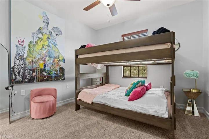 Carpeted bedroom with baseboards and ceiling fan