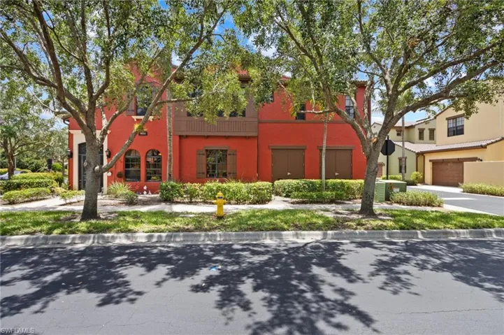 View of front of home with stucco siding, a garage, concrete driveway, and central air condition unit