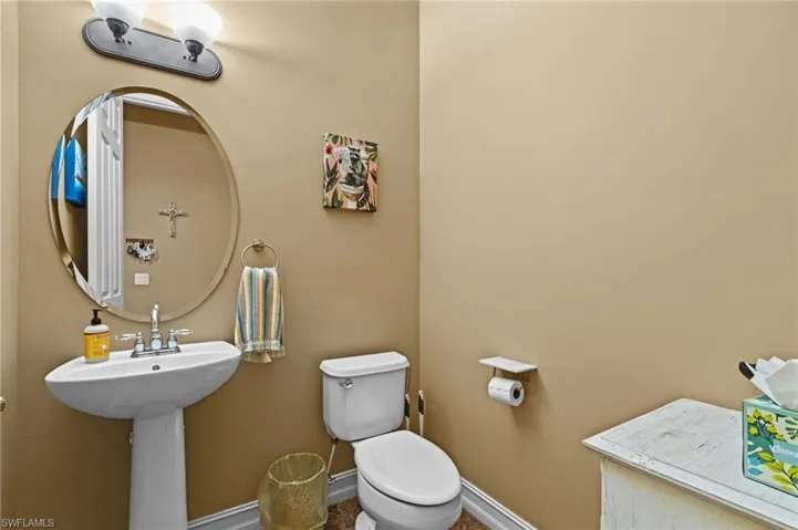 Bathroom featuring toilet and baseboards