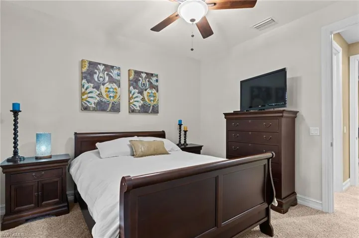 Bedroom with carpet floors, baseboards, and ceiling fan