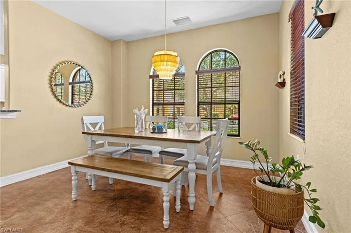 Dining room with baseboards and a chandelier