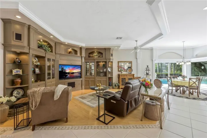 Entertainment-ready living room with built-in shelving and a media center.