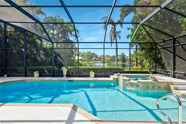 Sparkling pool with a serene tropical backdrop.