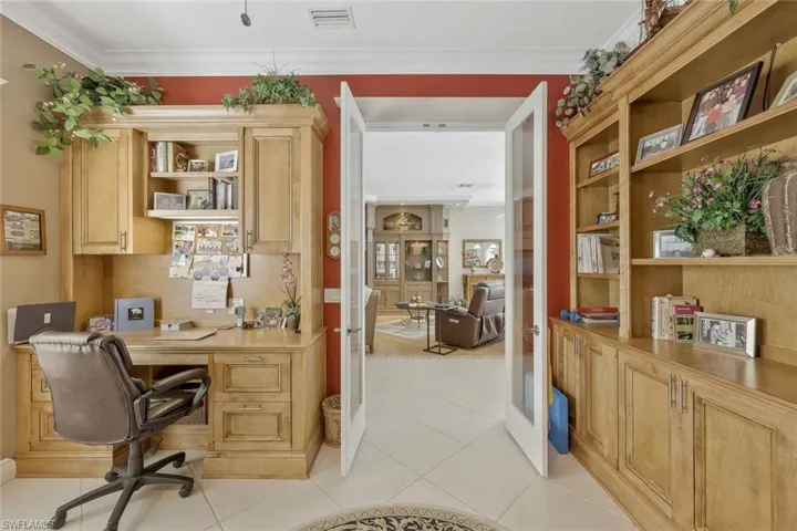 Home office with built-in shelving and a warm, inviting atmosphere.