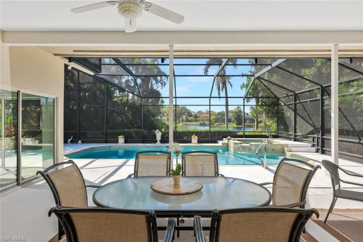 Screened-in outdoor seating area with a peaceful ambiance.