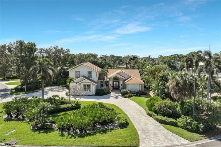 Stunning aerial view showcasing the home's beautifully landscaped front yard.