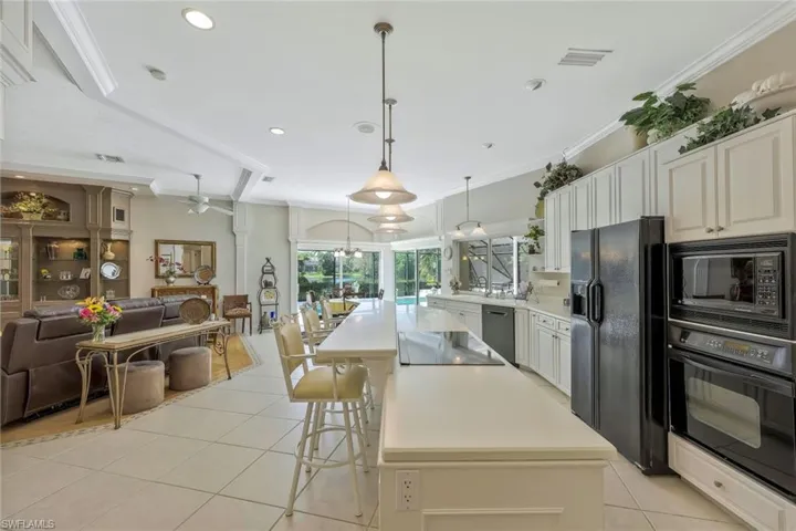 The sunny great room overlooks the pool and lake.