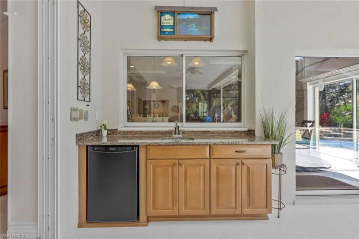 Outdoor sink, refrigerator and built in cabinets.