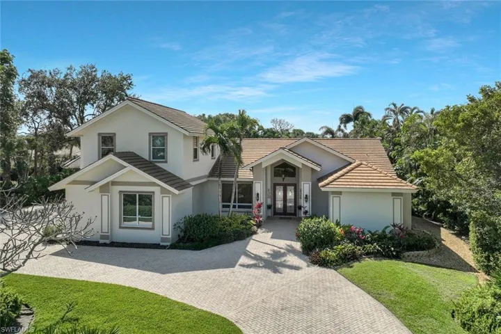 Beautiful front exterior with a grand entrance and well-manicured landscaping.