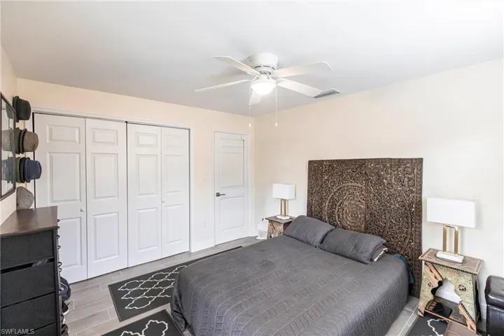 Bedroom featuring a closet, a ceiling fan, and wood finish floors