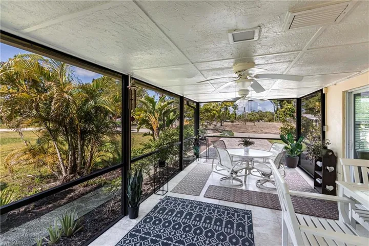 Sunroom featuring a ceiling fan and outdoor dining area