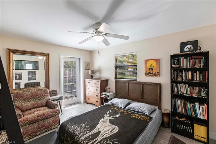 Bedroom featuring ceiling fan and access to outside