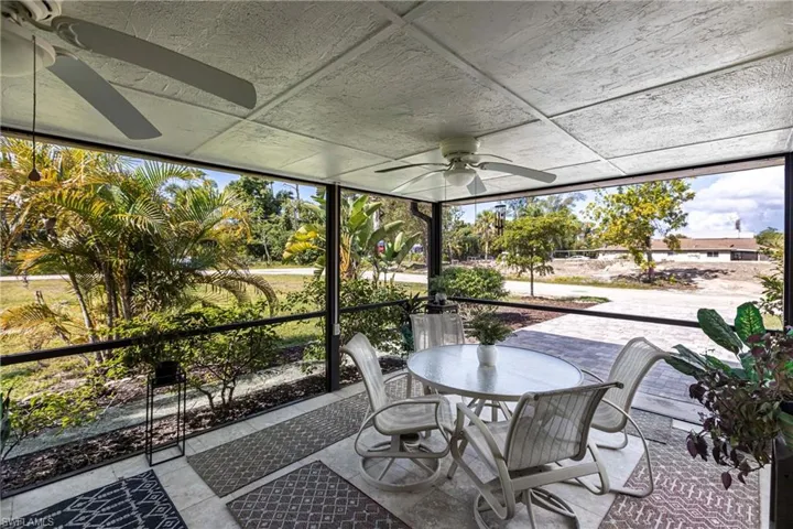 Sunroom / solarium featuring ceiling fan and outdoor dining area