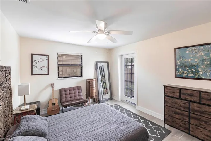 Bedroom featuring a ceiling fan, light wood-type flooring, and access to exterior