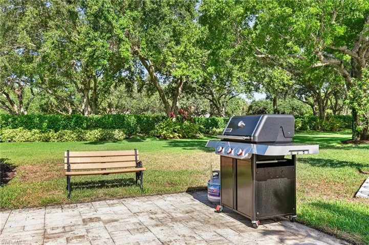 View of patio with a grill