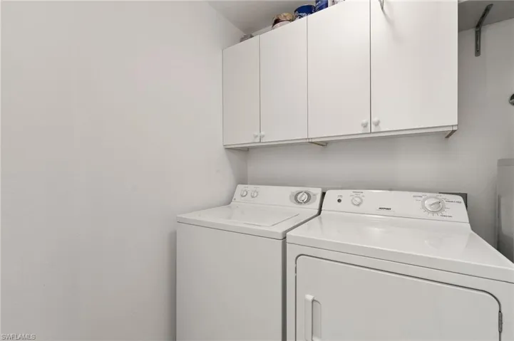 Washroom featuring washer and dryer and cabinets