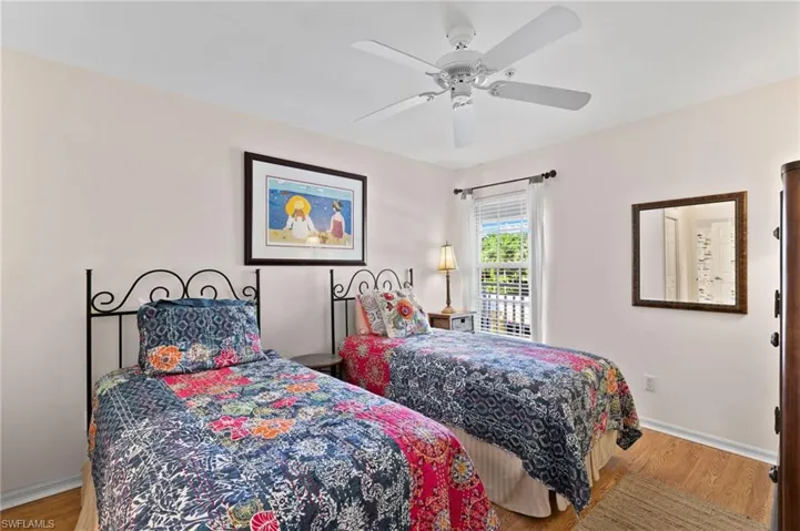 Bedroom with wood-type flooring and ceiling fan