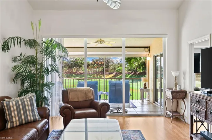 Living room with plenty of natural light, ceiling fan, and light hardwood / wood-style flooring