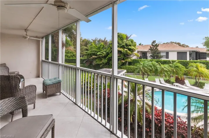 Balcony with view of pool and ceiling fan