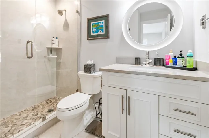 Bathroom featuring vanity and a shower stall