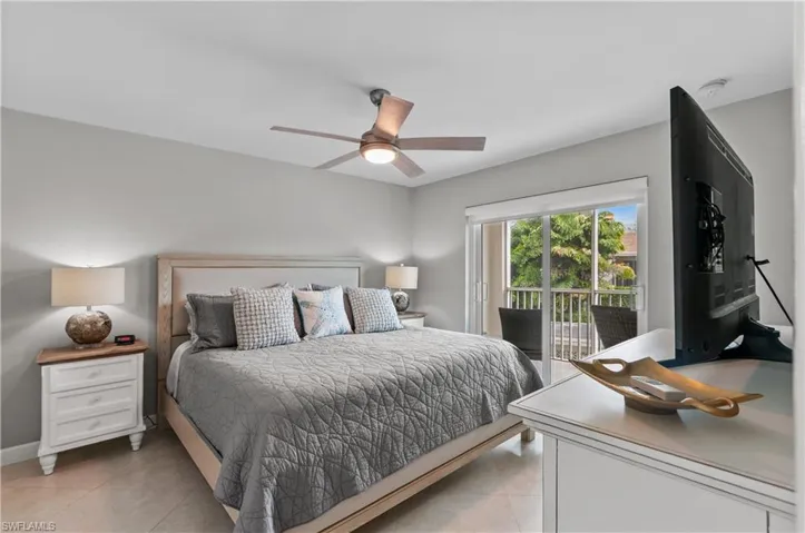 Bedroom featuring ceiling fan, access to outside, and light tile patterned floors