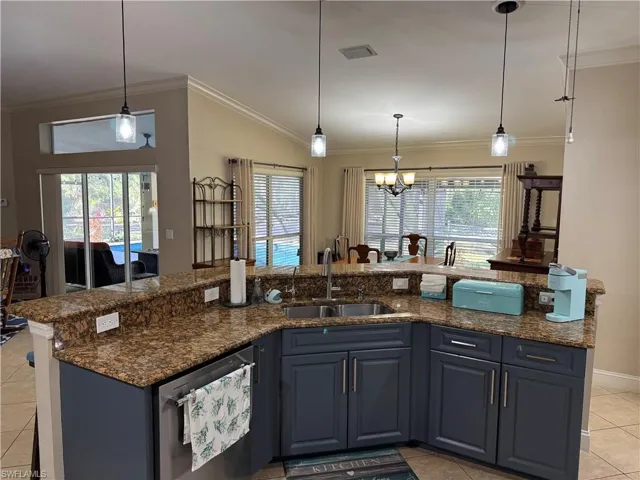 Tiled living room featuring crown molding, a ceiling fan, and a fireplace