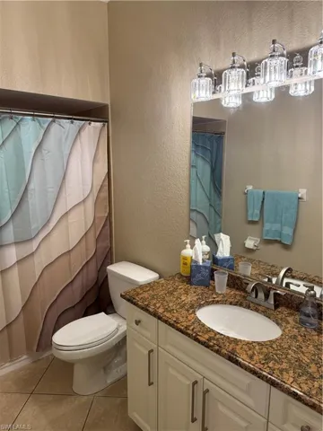 Full bathroom featuring vanity, a stall shower, a garden tub, and tile patterned flooring