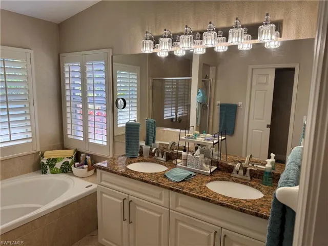 Living area with light tile patterned floors, ceiling fan, and lofted ceiling