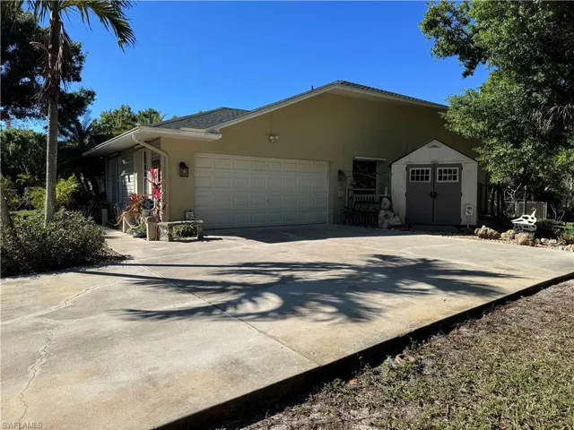 Property entrance featuring covered porch and french doors