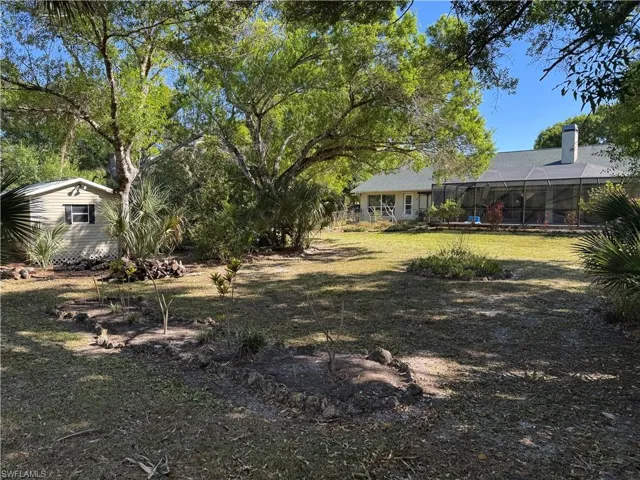 View of yard with view of wooded area