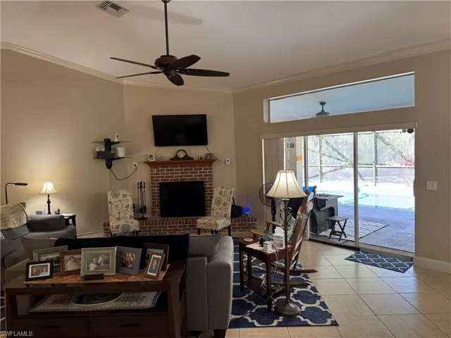 Entrance foyer featuring crown molding, healthy amount of natural light, french doors,